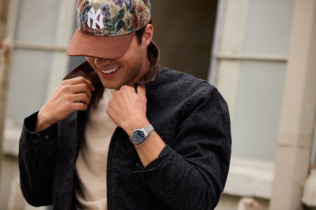 Lifestyle portrait showing the Citizen NJ0200-50M TSUYOSA blue dial watch worn with a casual jacket
