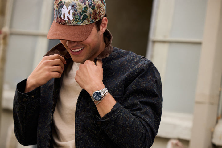 Lifestyle portrait showing the Citizen NJ0200-50M TSUYOSA blue dial watch worn with a casual jacket