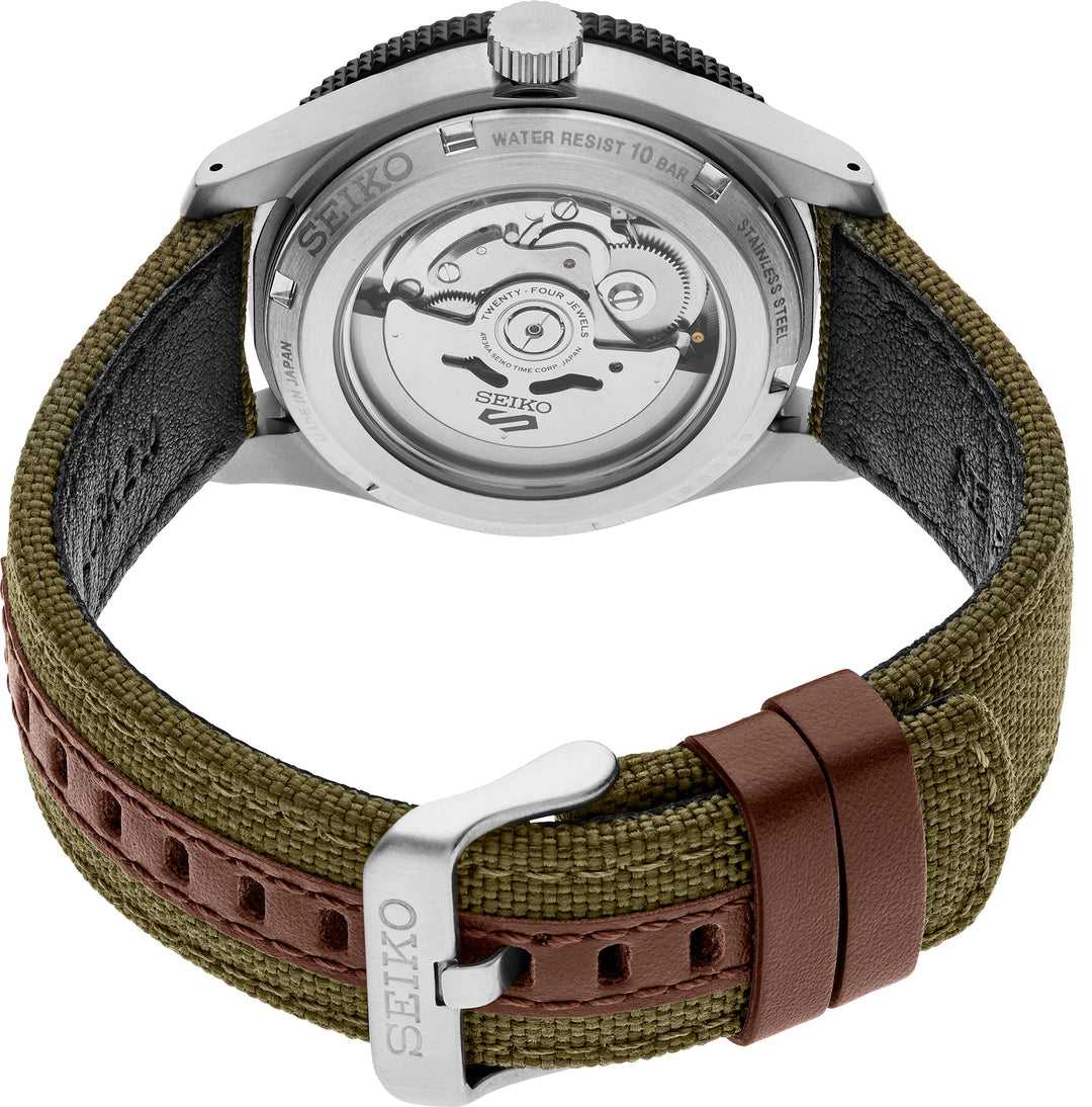 Seiko HDB008 exhibition caseback showing the automatic movement, khaki nylon strap, leather keepers and buckle